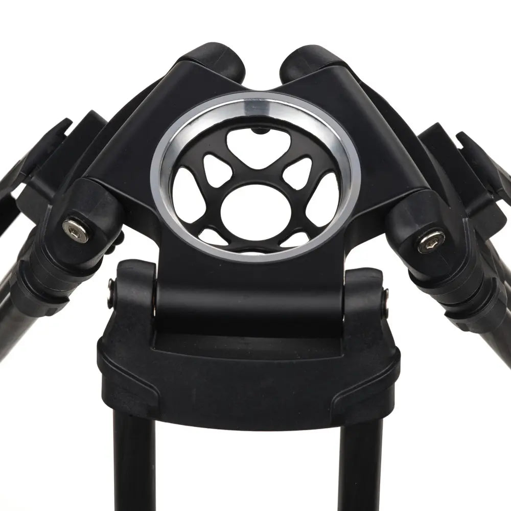 Close-up of a black metal tripod with central circular component on a white background