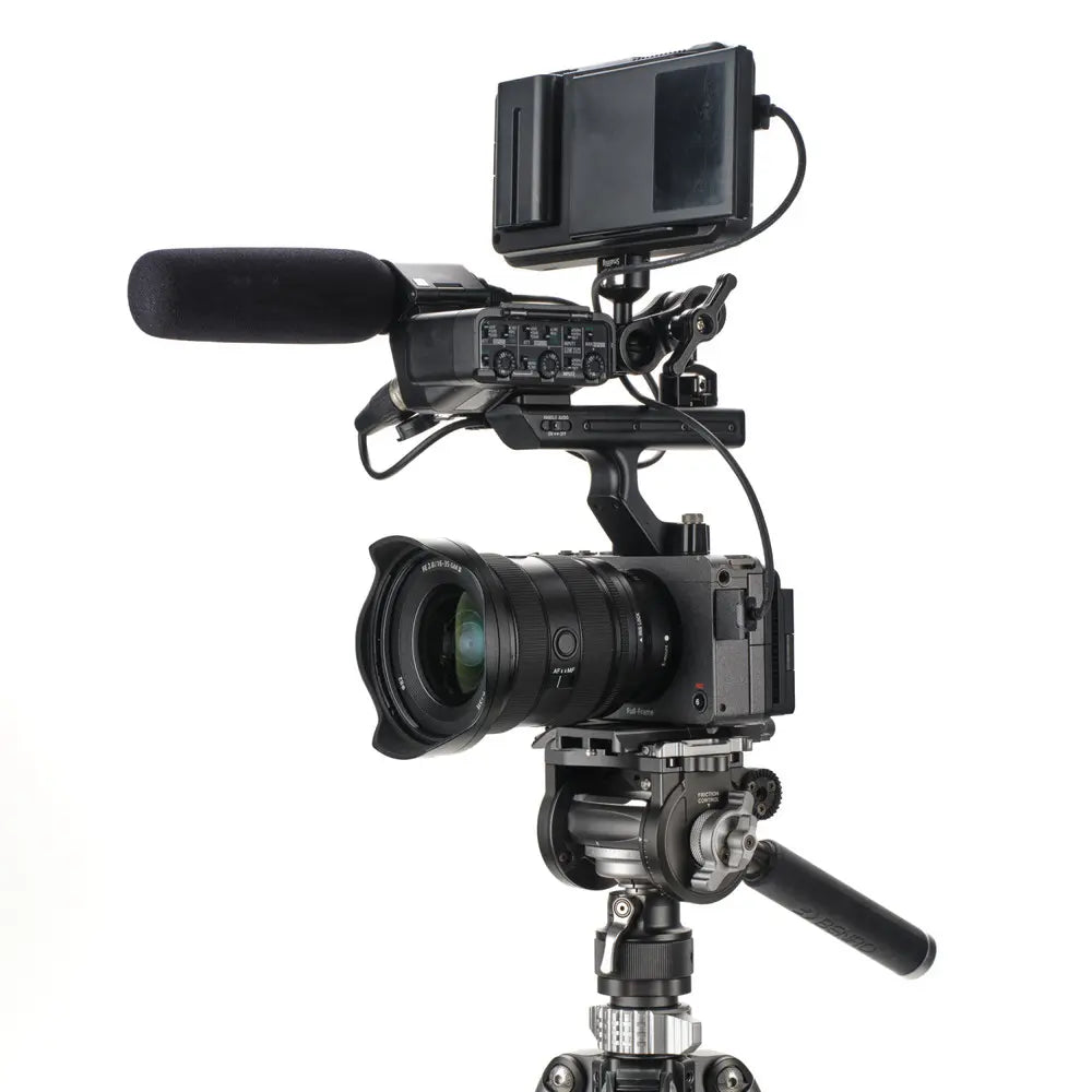 Professional video camera with microphone and monitor on a white background