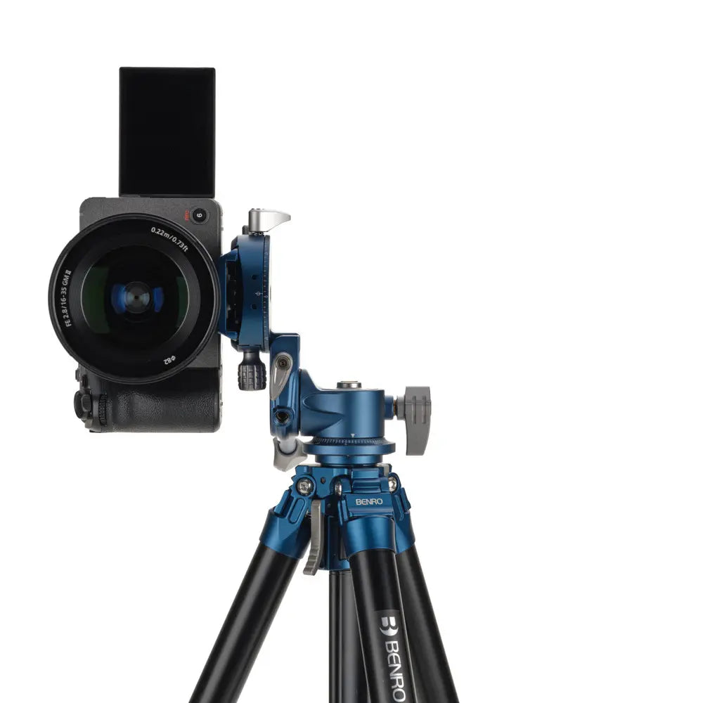 Camera mounted on a blue tripod with a white background