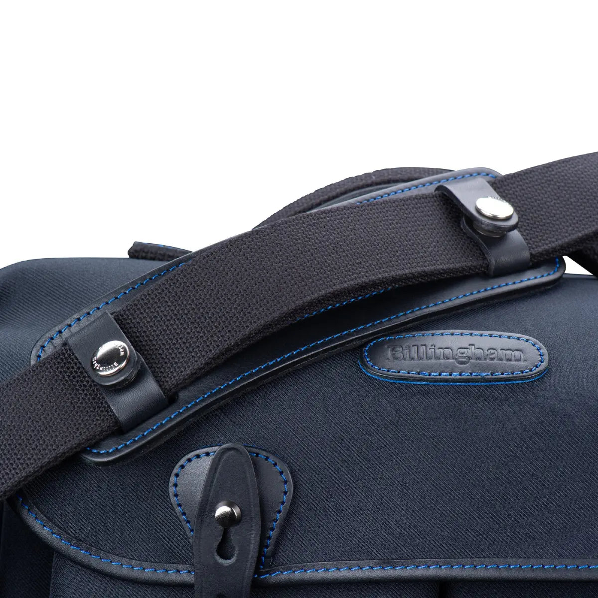Close-up of a navy blue bag with leather straps and 'Billingham' branding on a white background.