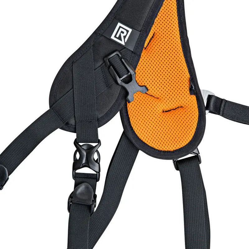 Black and orange dog harness with a visible brand logo on a white background