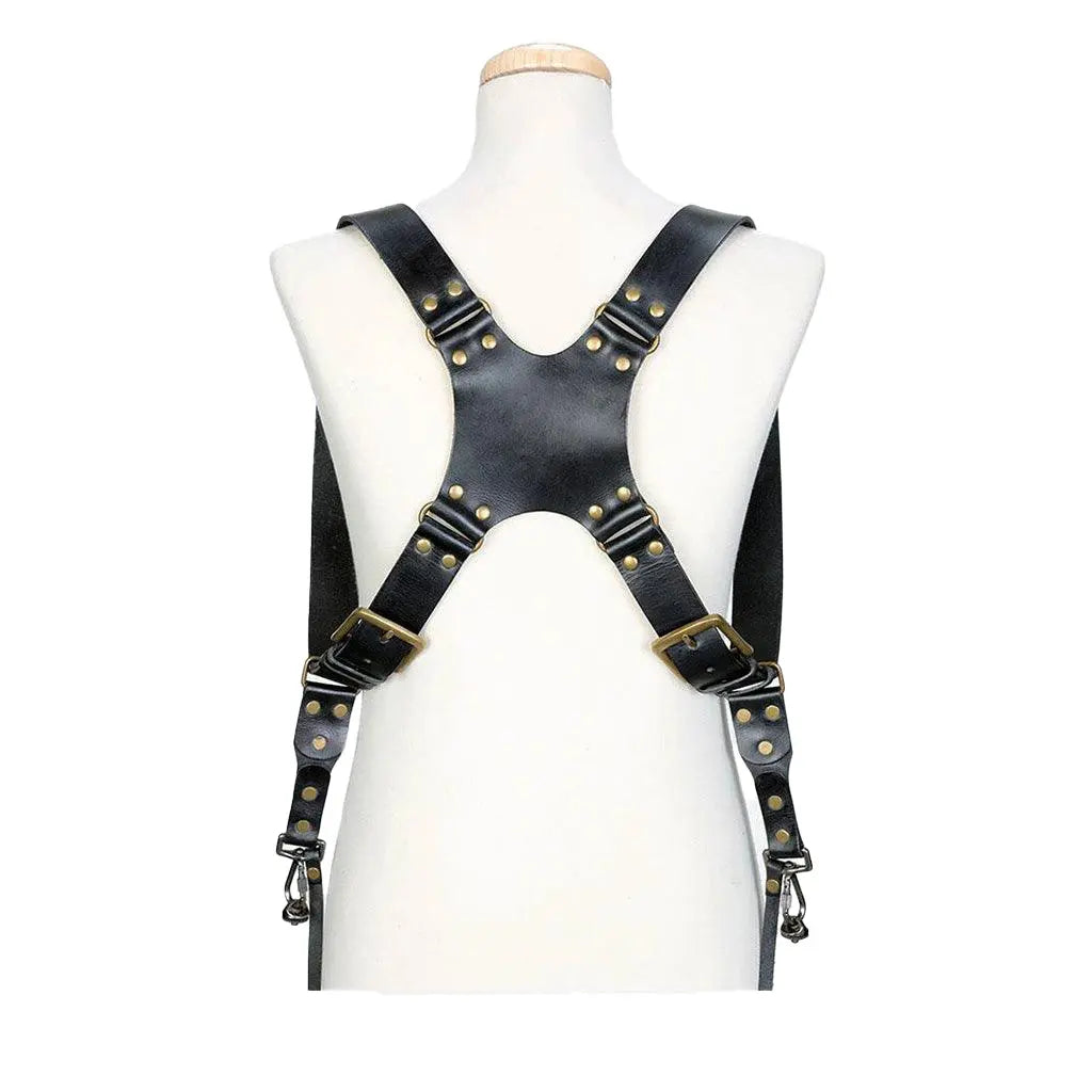 Black leather harness with gold studs on a mannequin against a white background