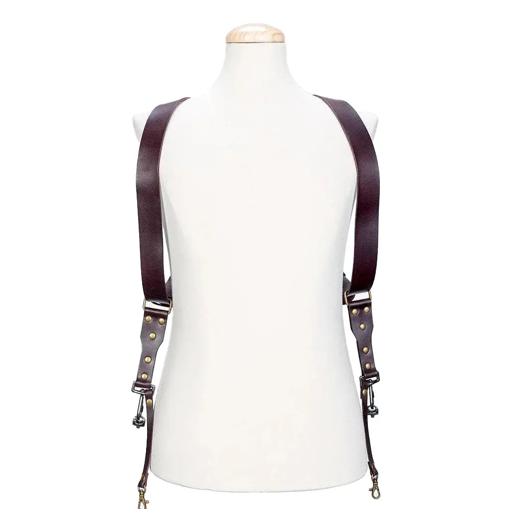 Brown leather suspenders on a mannequin against a white background