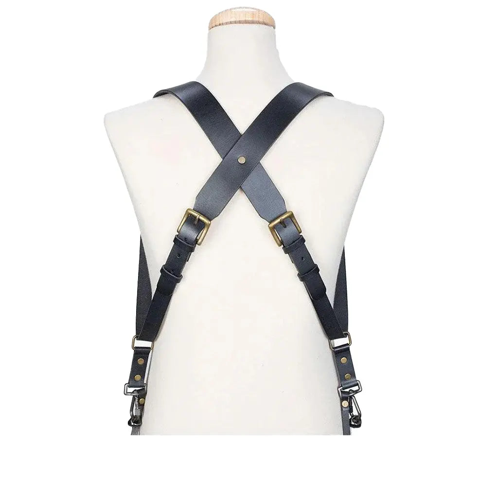 Black leather harness on a mannequin torso against a white background