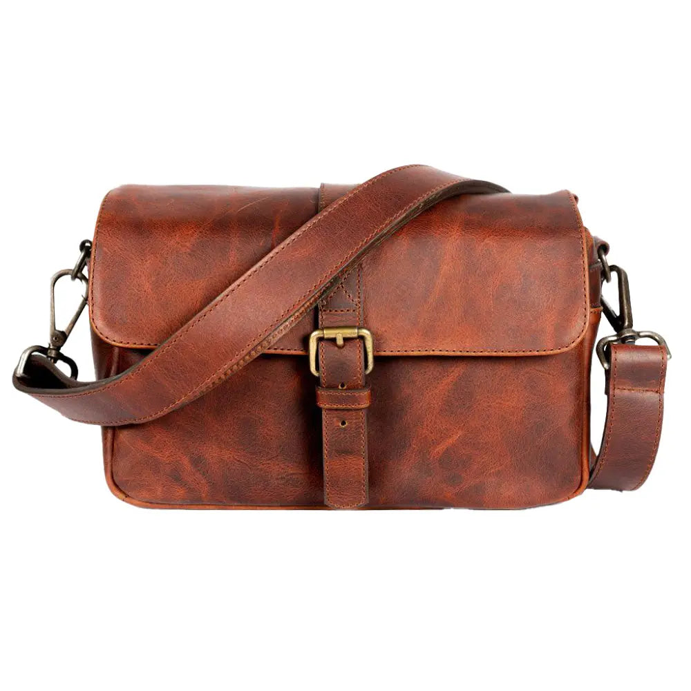 Brown leather satchel bag with a strap on a white background