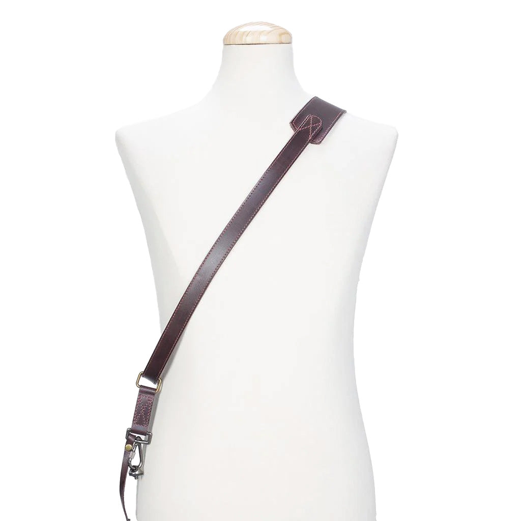 Brown leather strap on a mannequin with a white background