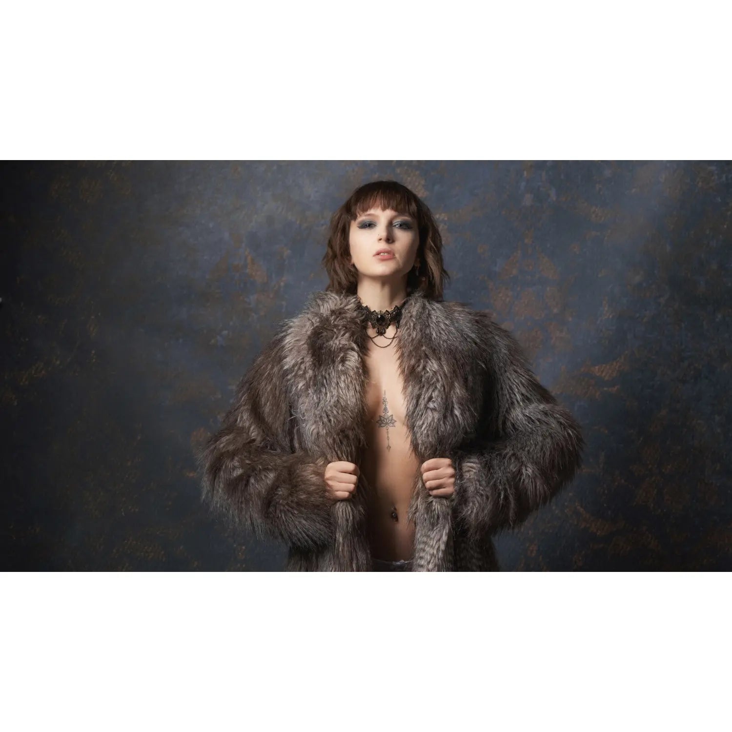 Person wearing a fur coat against a textured dark background