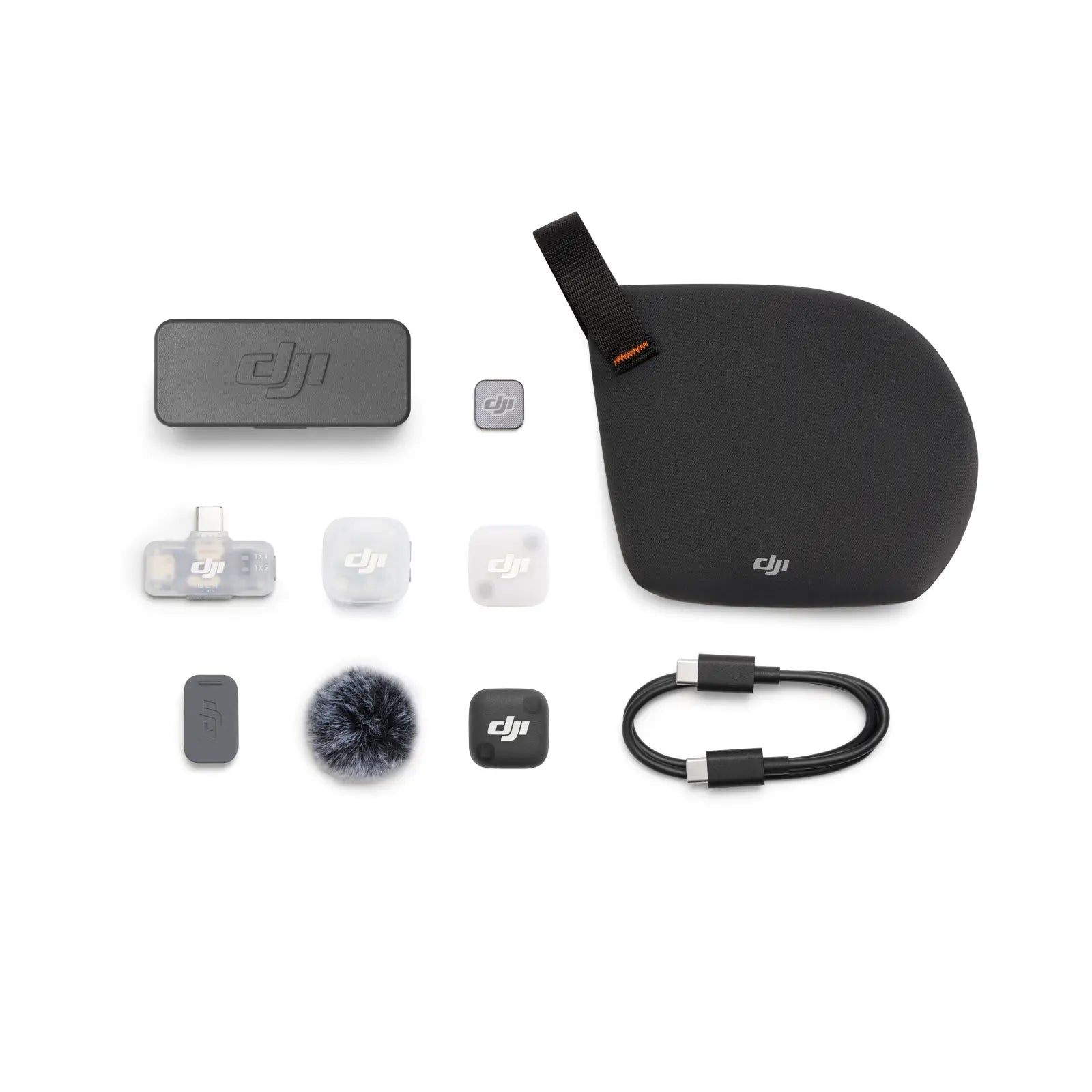 Collection of DJI accessories including a case, microphone, and other small components on a white background.