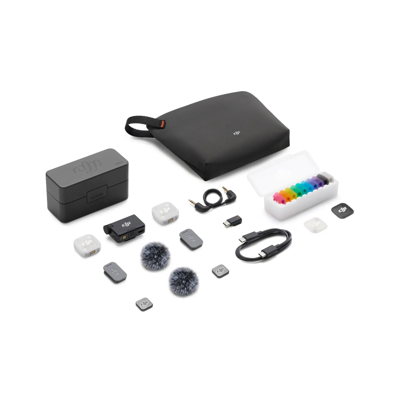 Collection of electronic accessories including a black case, white box with colorful items, and various small devices on a white background.