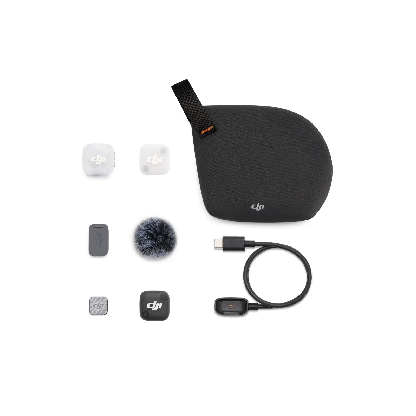 Collection of DJI accessories including a case, microphone, and cables on a white background