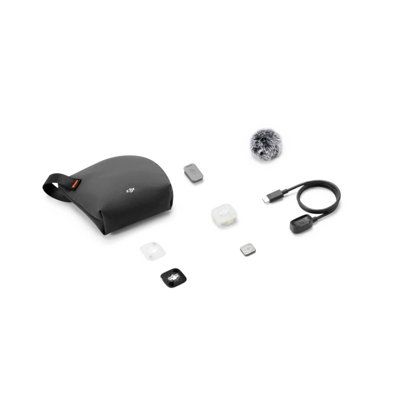 A DJI-branded black protective pouch shown with several included accessories on a clean white background, including a small furry windscreen, USB-C cable, and several small square filter pieces.