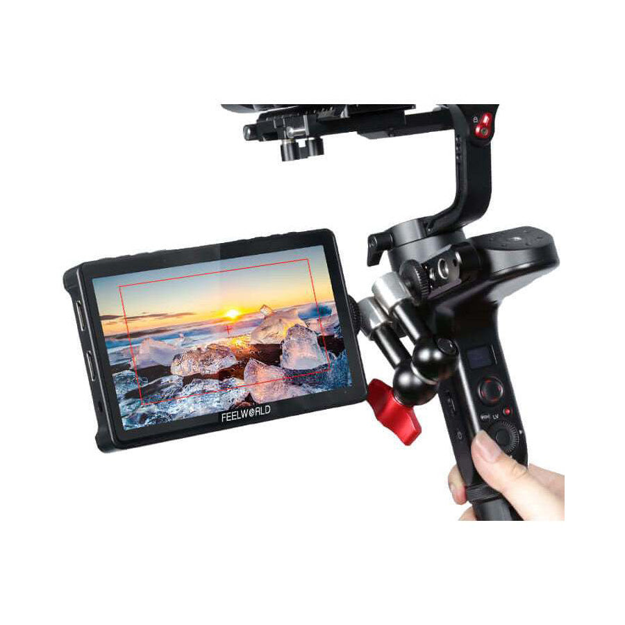 Handheld camera stabilizer with a monitor displaying a scenic view, on a white background.