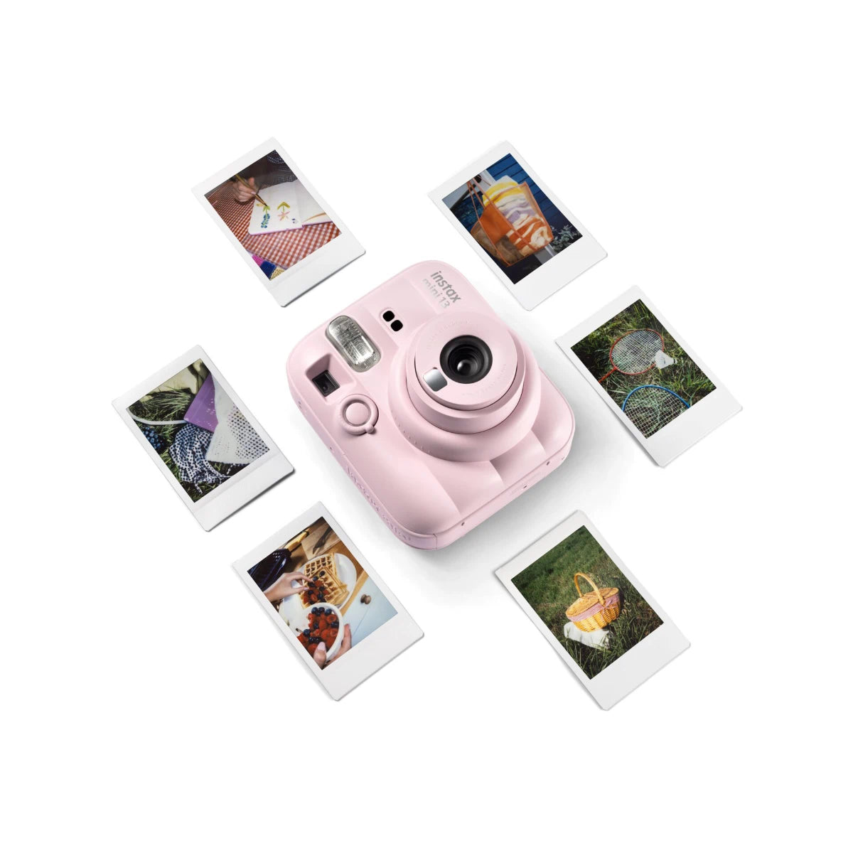 Pink instant camera with instant photos on a white background