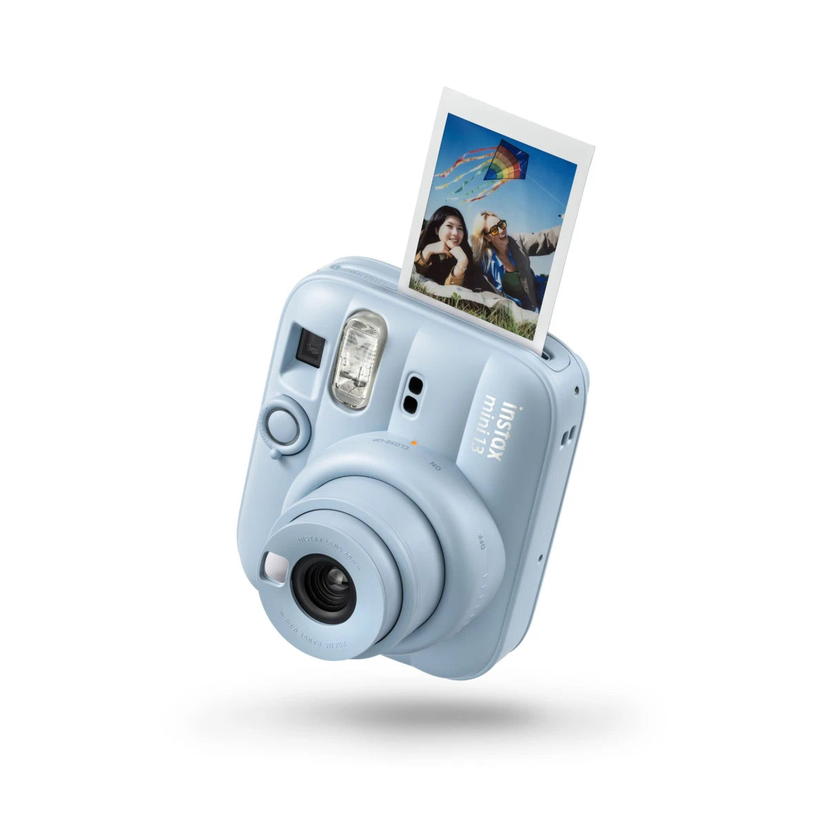 Light blue instant camera with a printed photo on a white background