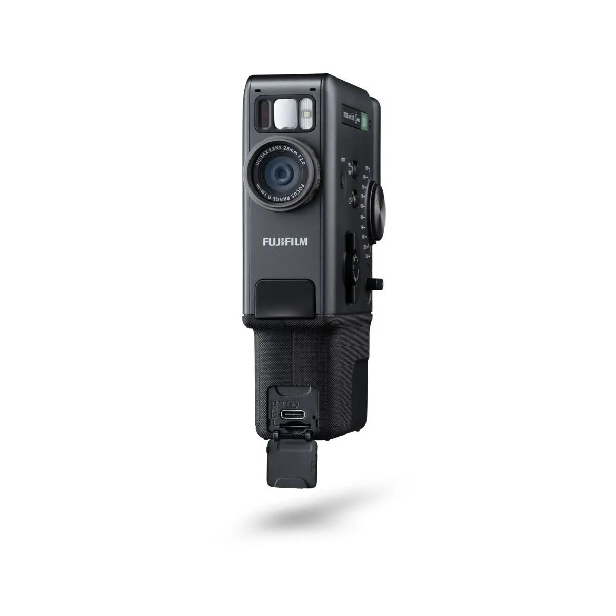 A black Fujifilm Instax Mini Evo Cinema camera with an attached battery grip, shown from a front-three-quarter angle against a solid white background.