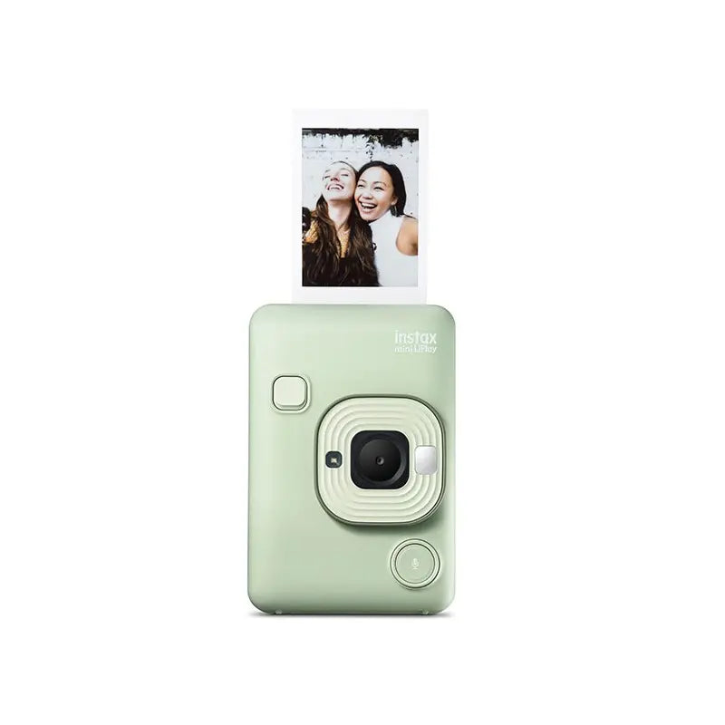 Mint green instant camera with a printed photo on a white background