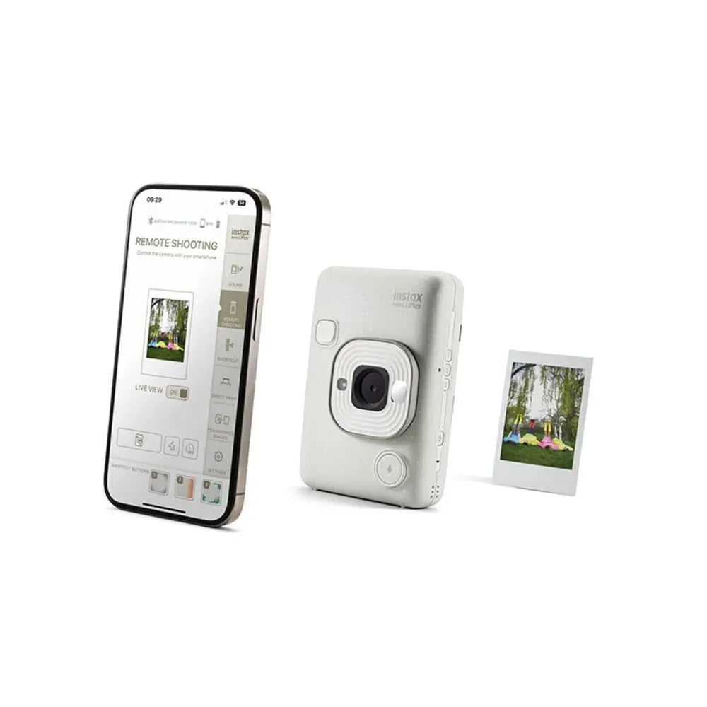 Smartphone displaying a camera app, next to a white instant camera and a small photo print on a white background.