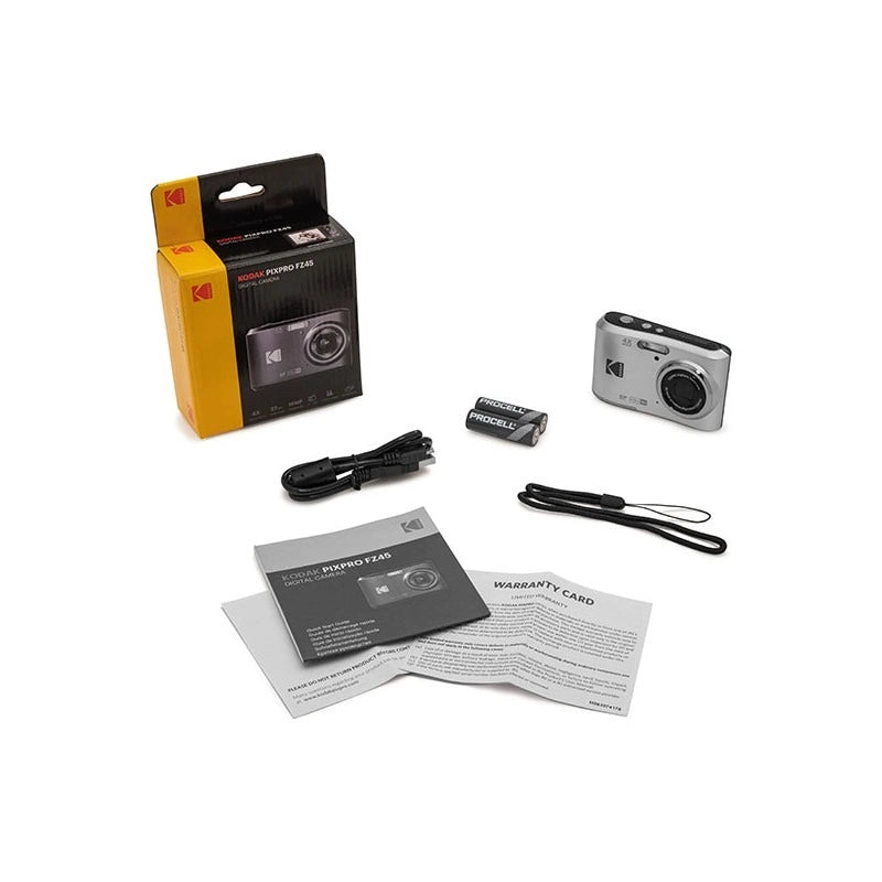 A Kodak digital camera shown with its retail packaging, battery, charging cable, manual, and warranty card on a plain white background.