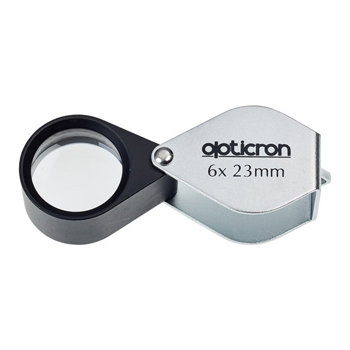 Opticron magnifying glass with 6x magnification and 23mm diameter on a white background