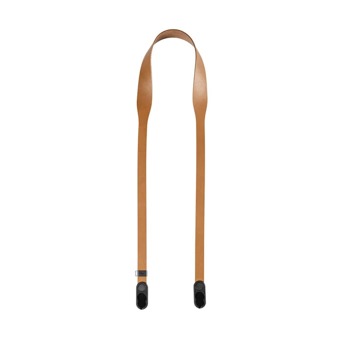 Tan leather strap with black ends on a white background