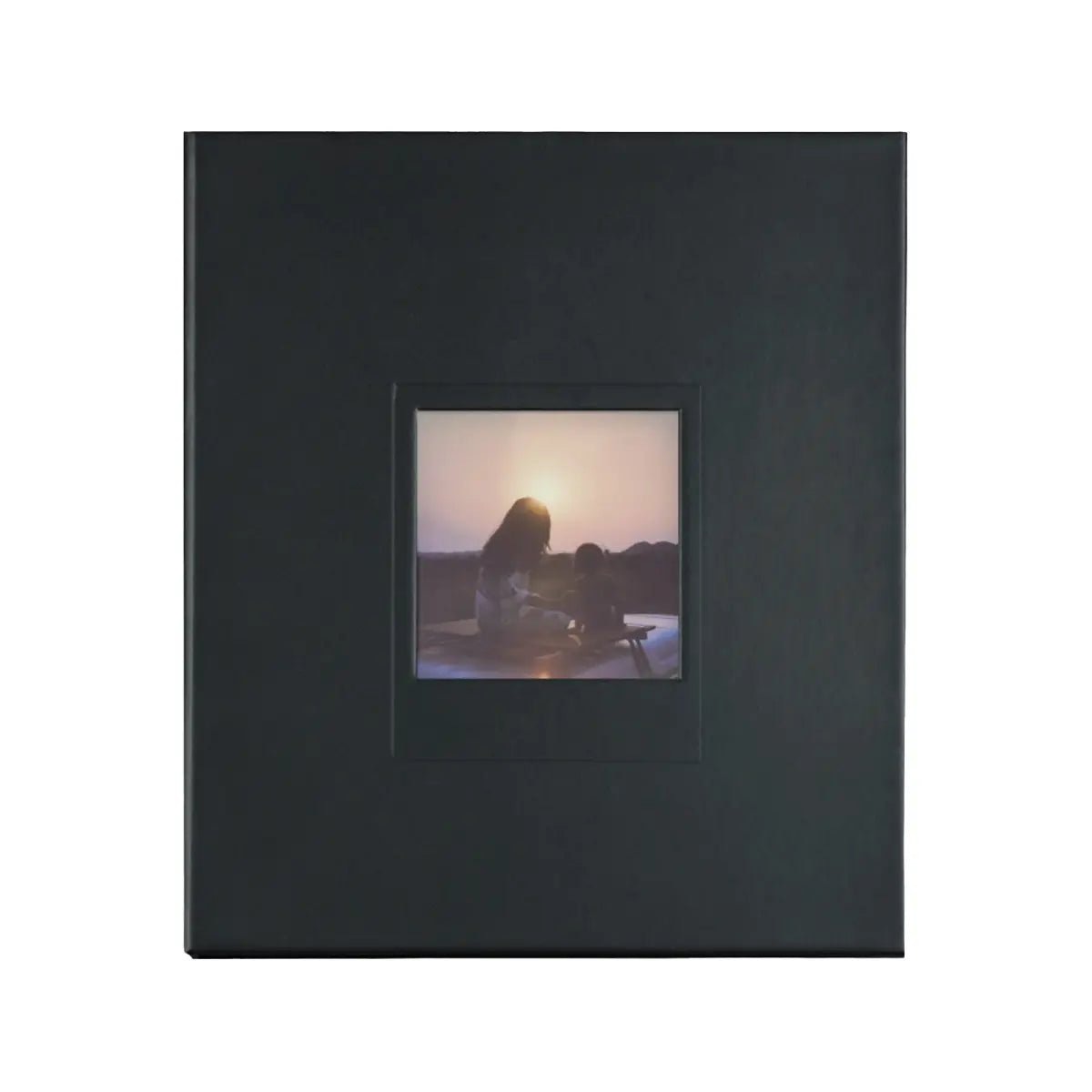 Black photo album with a small square window displaying a sunset scene.