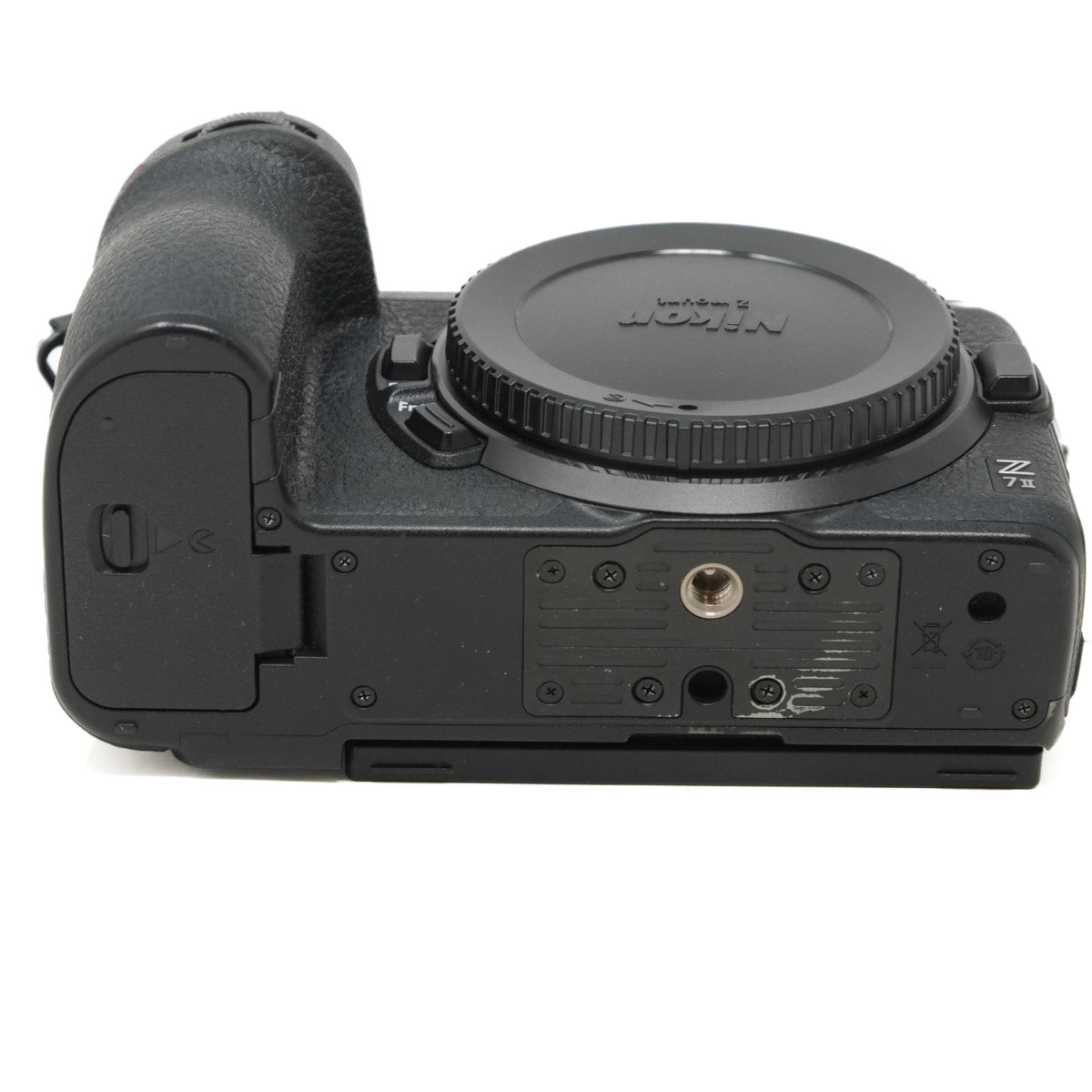 Bottom view of a black camera body on a white background