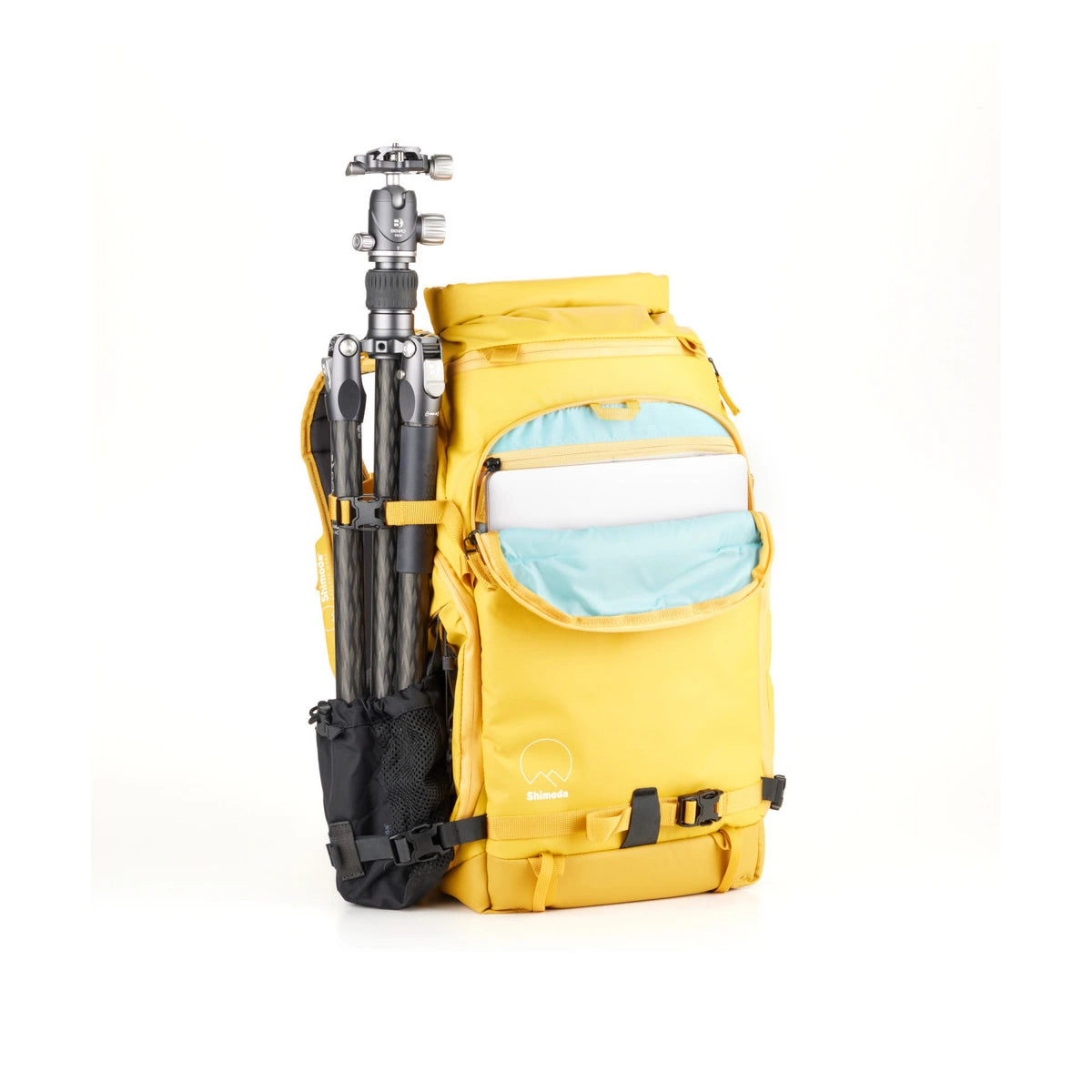 A bright yellow camera backpack with a light blue interior pocket, shown on a white background with a tripod tucked into its side gear loop.