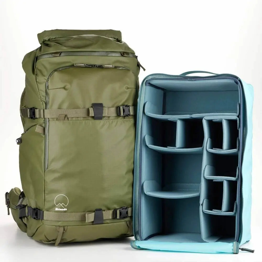 Green backpack and blue modular organizer on a white background