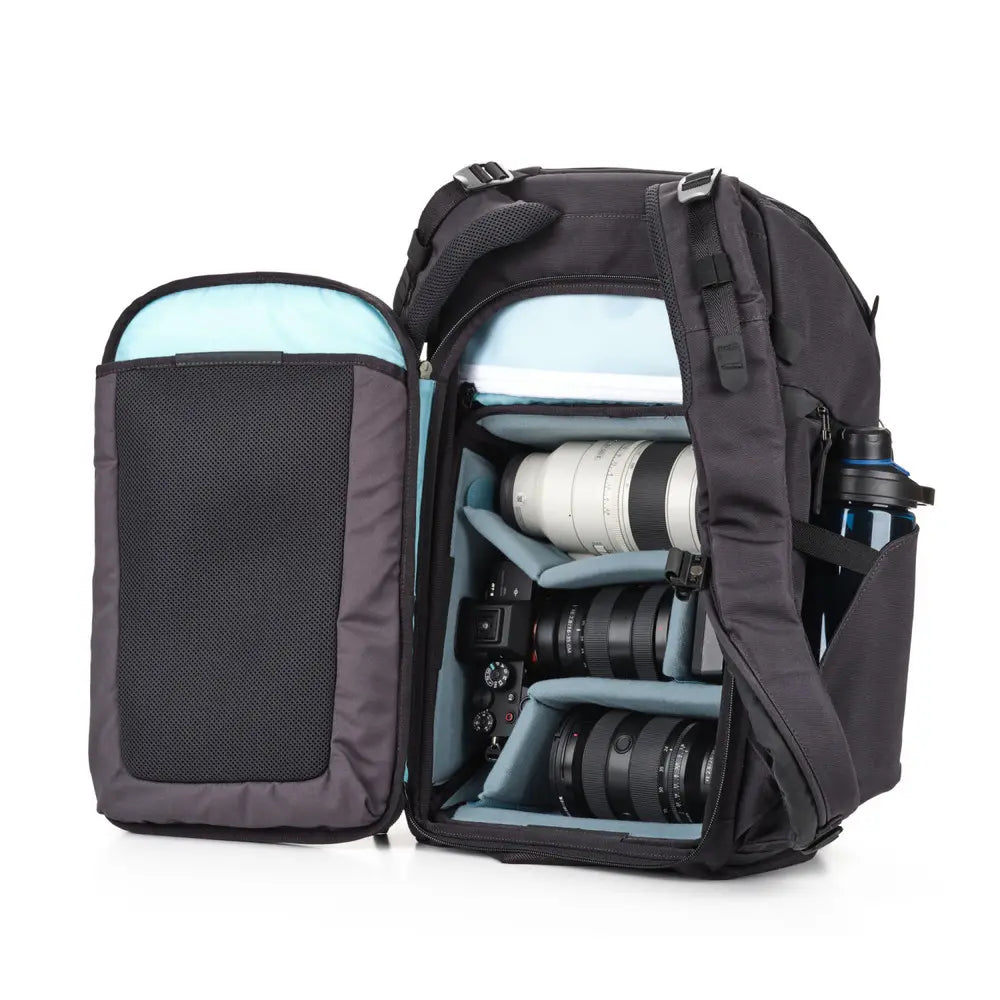 Camera backpack with camera equipment inside on a white background