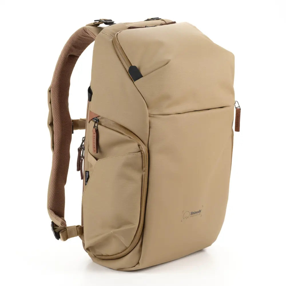 Beige backpack with multiple pockets on a white background