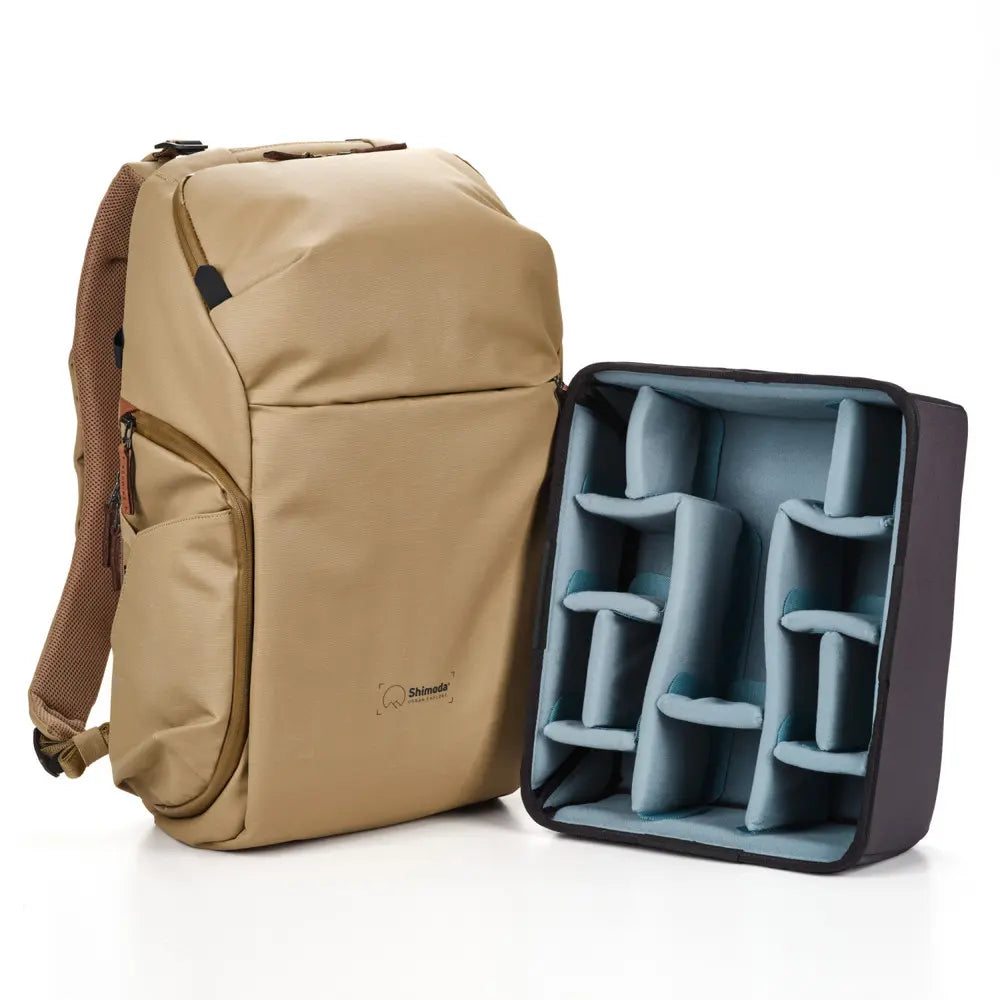 Beige backpack with a compartmentalized blue interior on a white background