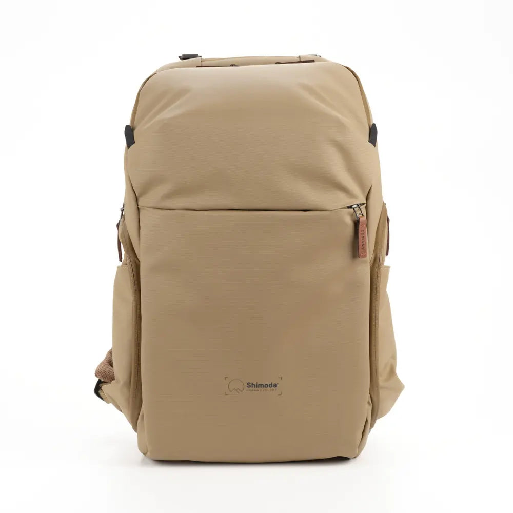 Beige backpack with a visible brand logo on a white background