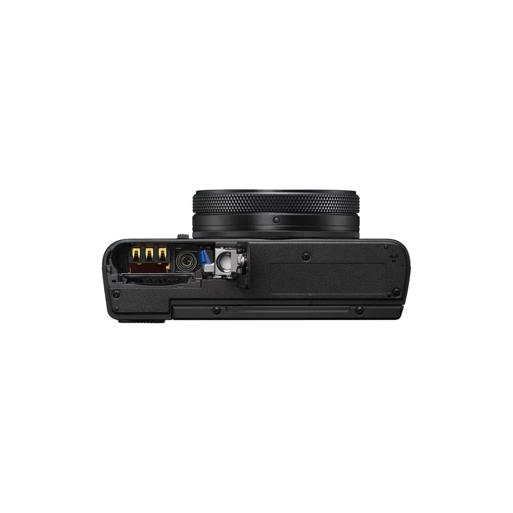 A black Sony RX100 VII compact mirrorless camera with the battery door open, shown from a bottom profile view against a white background.