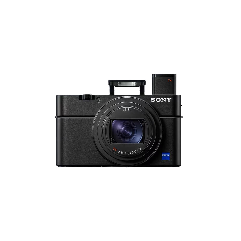 Sony compact digital camera with a black body, featuring a Zeiss lens and an attached battery grip, shown against a light gray background.