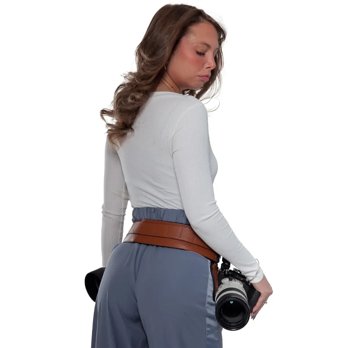 Woman wearing a brown belt with a camera on a white background