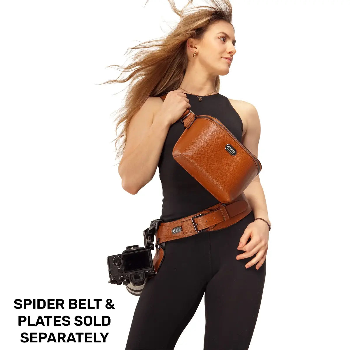 Woman wearing a brown leather belt with a camera attached, on a white background.