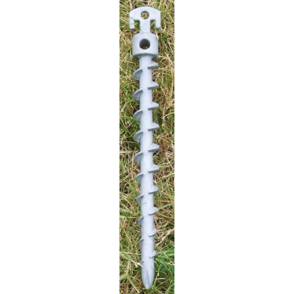 Metal screw or anchor on grass