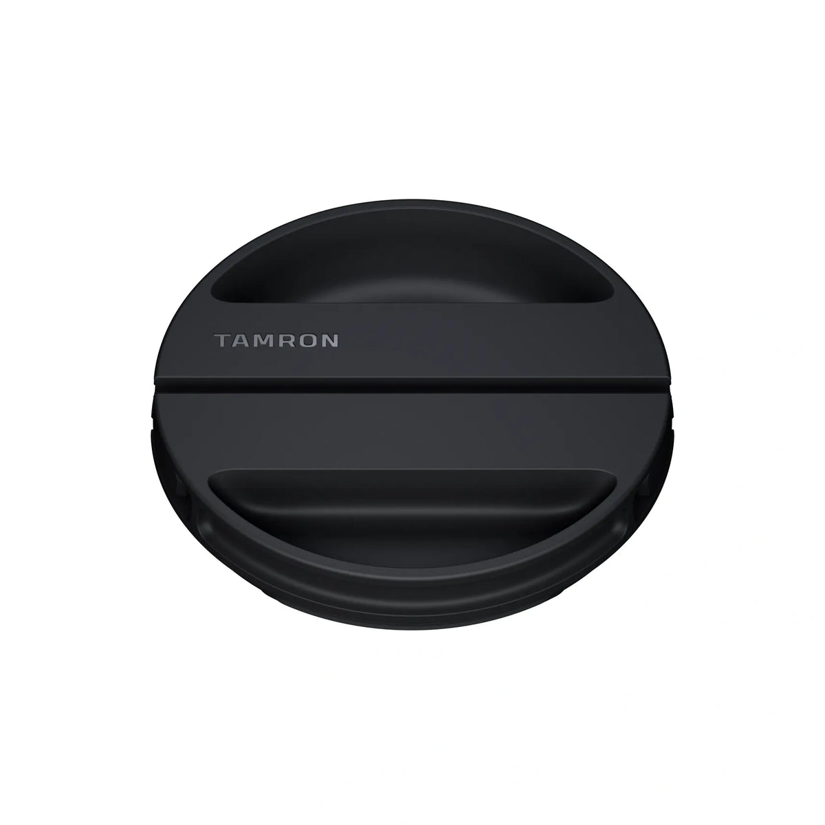 A black Tamron lens cap with a matte finish and the brand name 'TAMRON' printed in white on the front, shown against a solid white background.