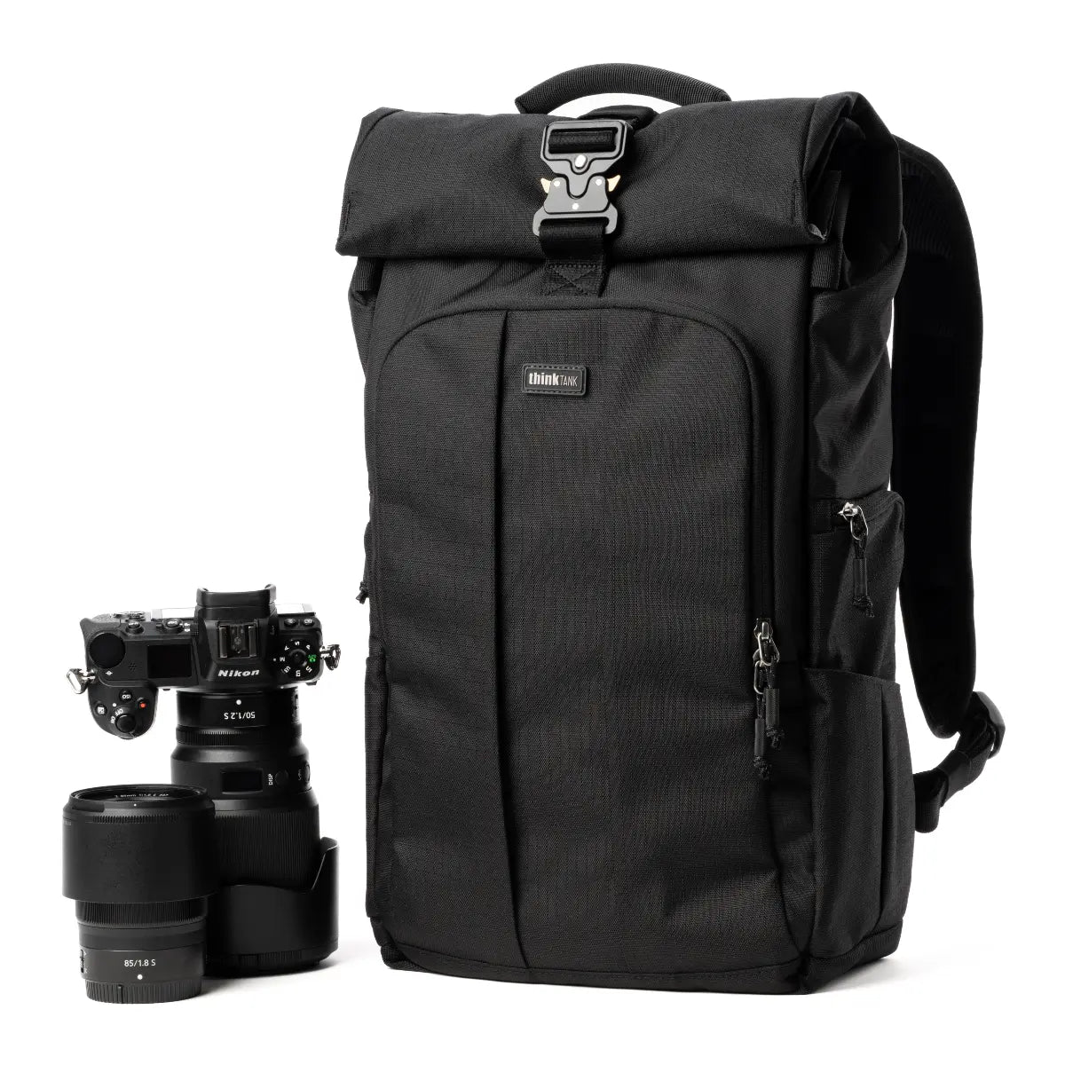 Black backpack with camera equipment on a white background