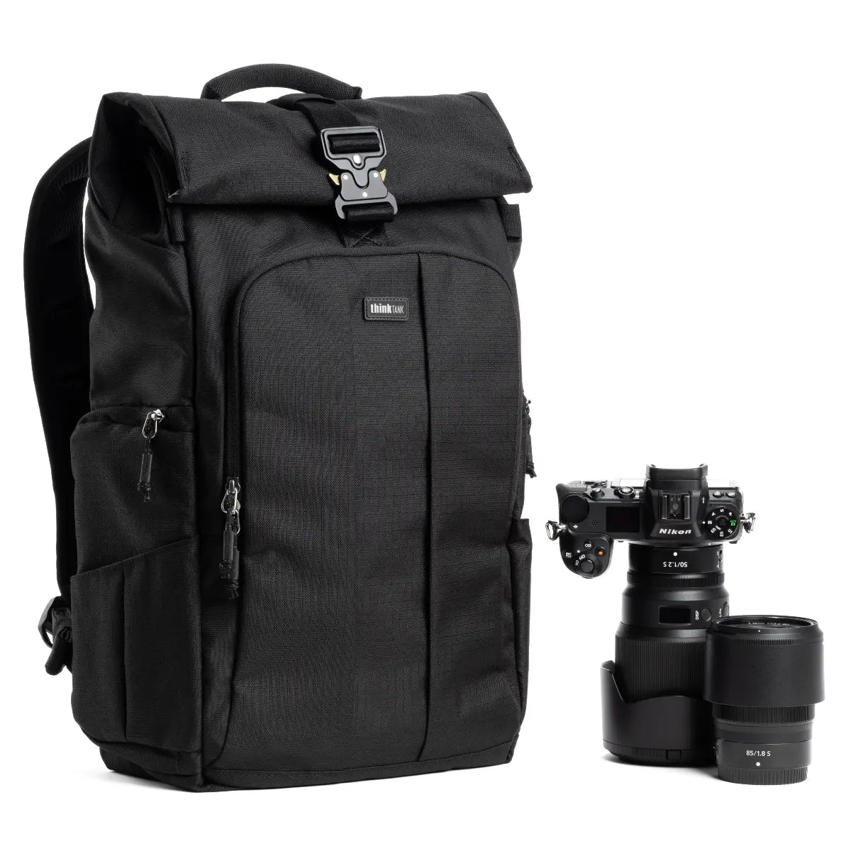 Black backpack with camera equipment on a white background