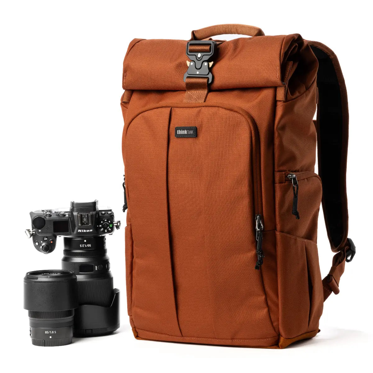 Brown backpack with camera equipment on a white background
