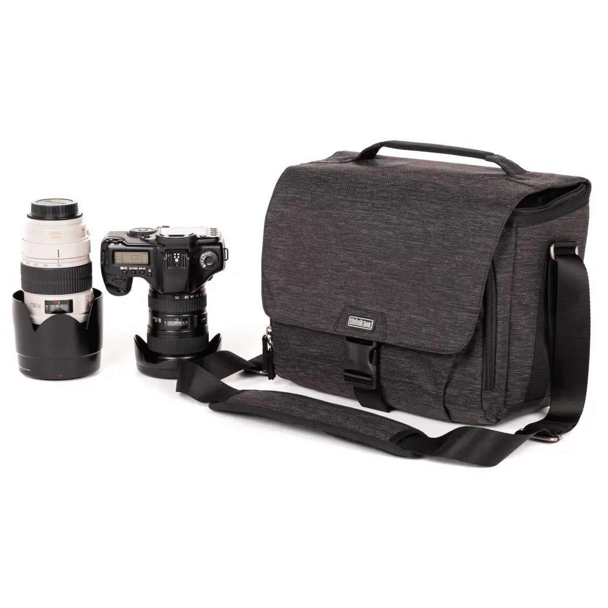 Gray camera bag with a camera and lens on a white background