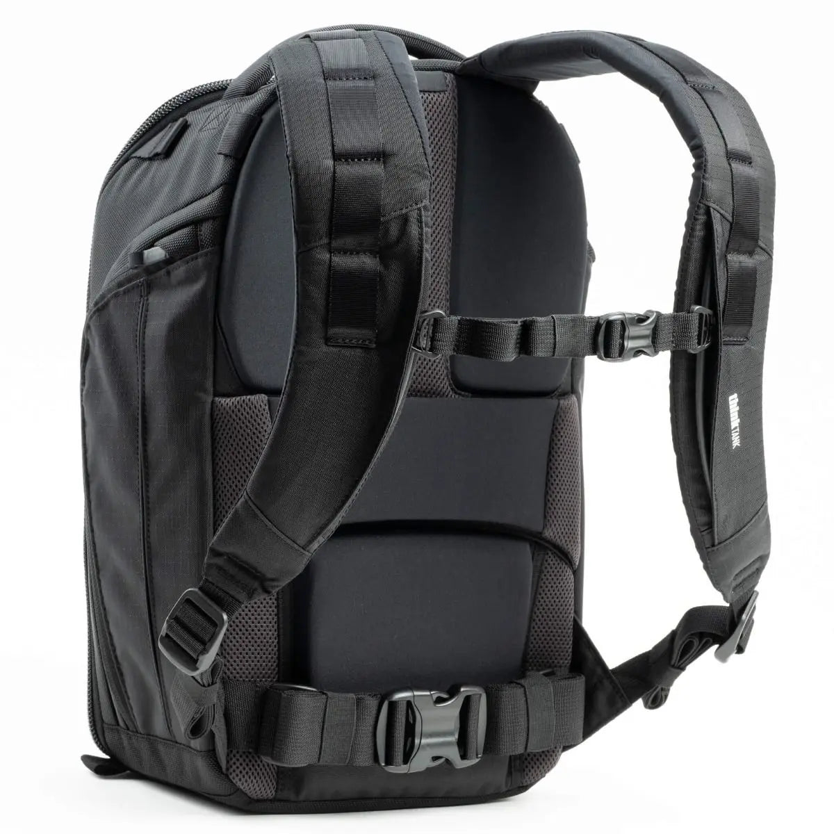 Black backpack with multiple straps and buckles on a white background