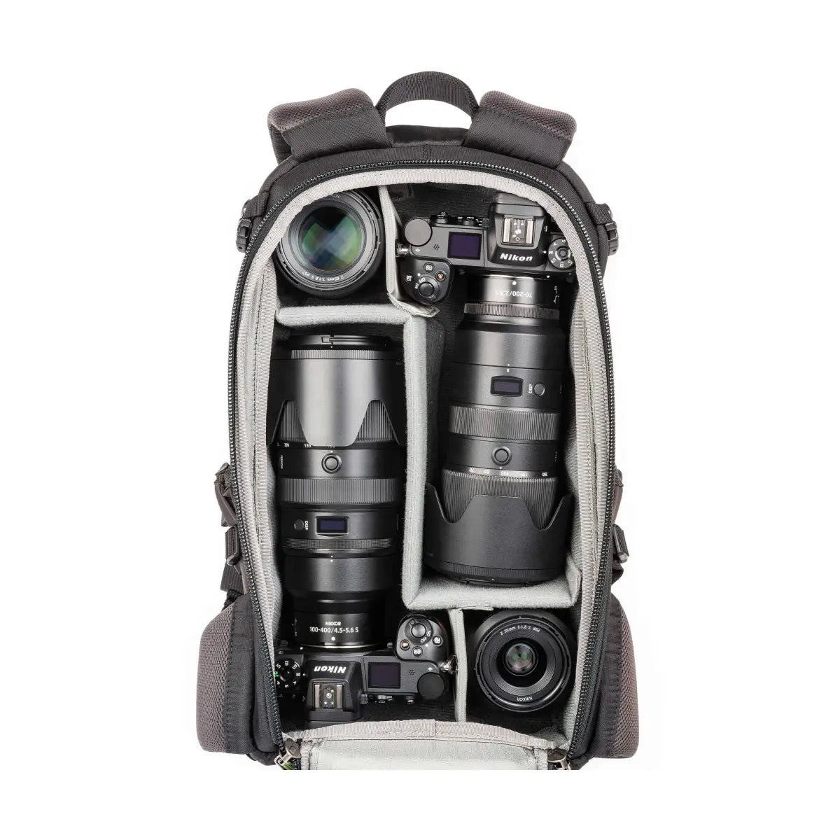 Camera backpack with camera equipment including lenses and a Nikon camera on a white background