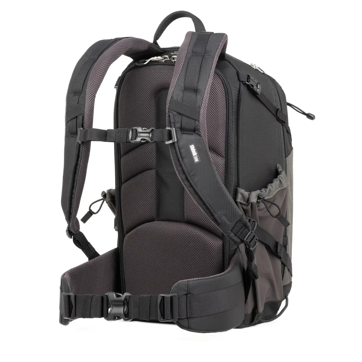Black backpack with multiple straps and compartments on a white background