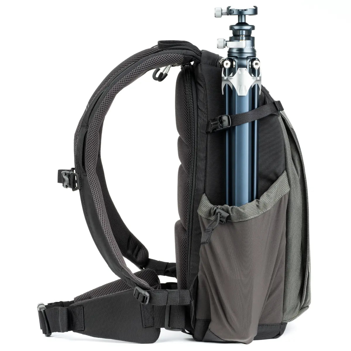 Black backpack with a camera tripod inside on a white background