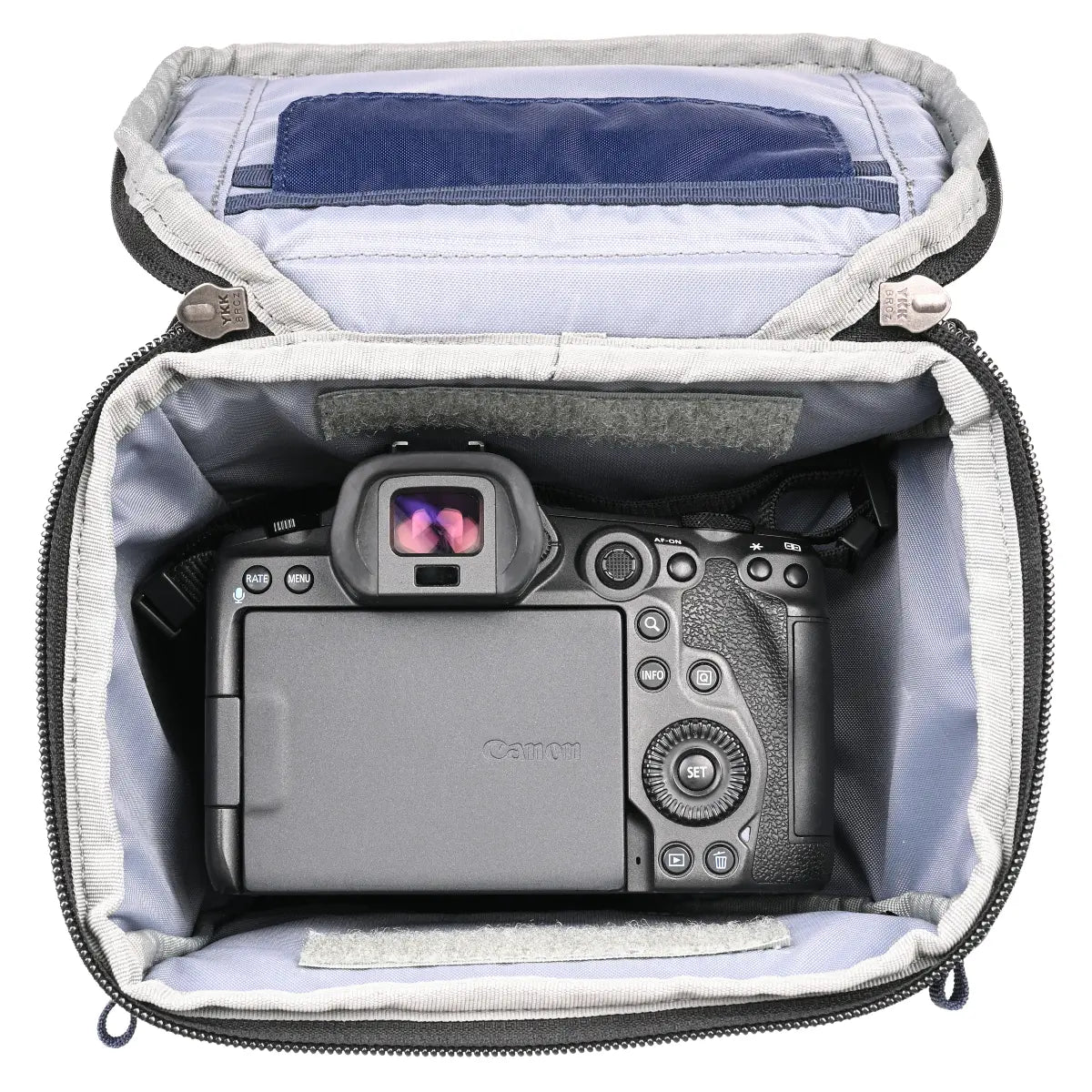 Canon camera inside a gray camera bag with a white interior
