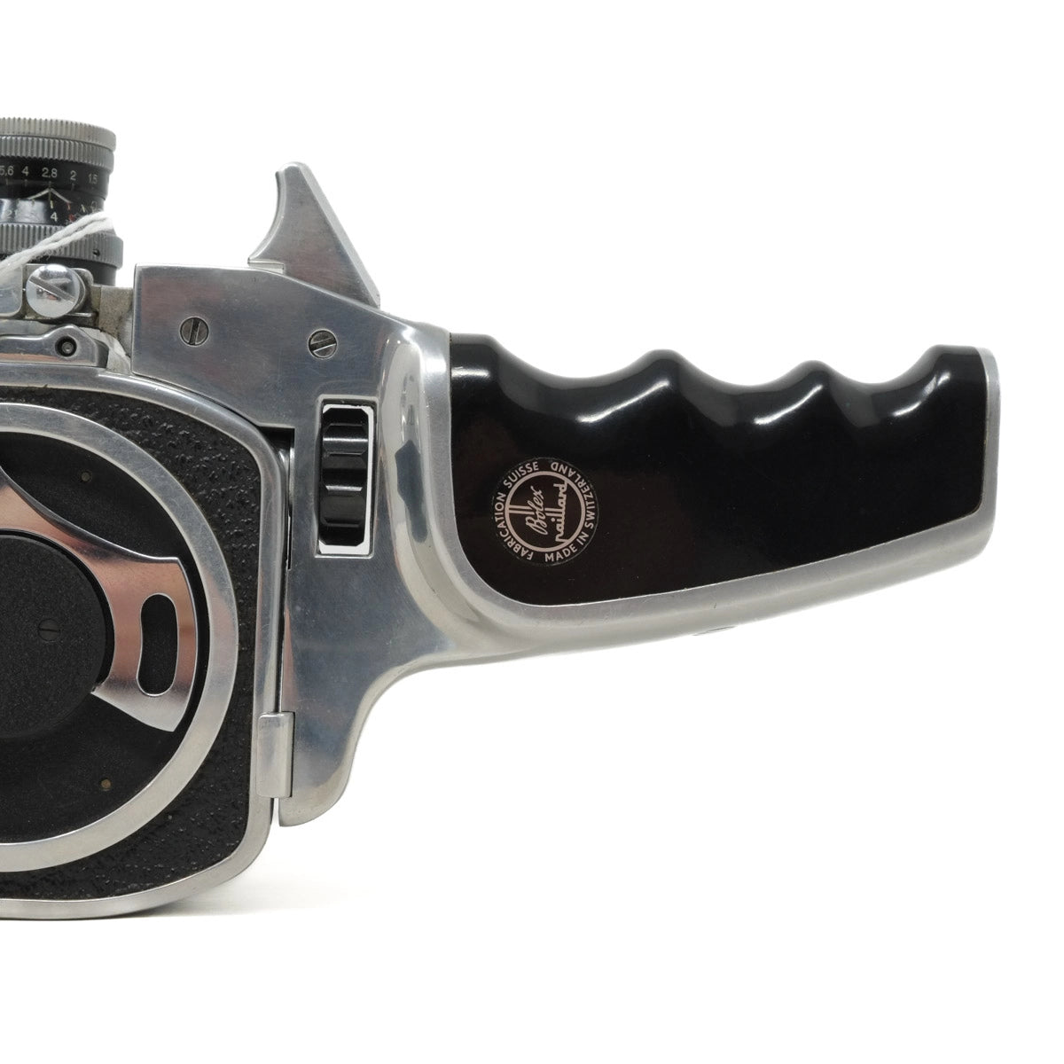 Close-up of a vintage camera lens and handle on a white background
