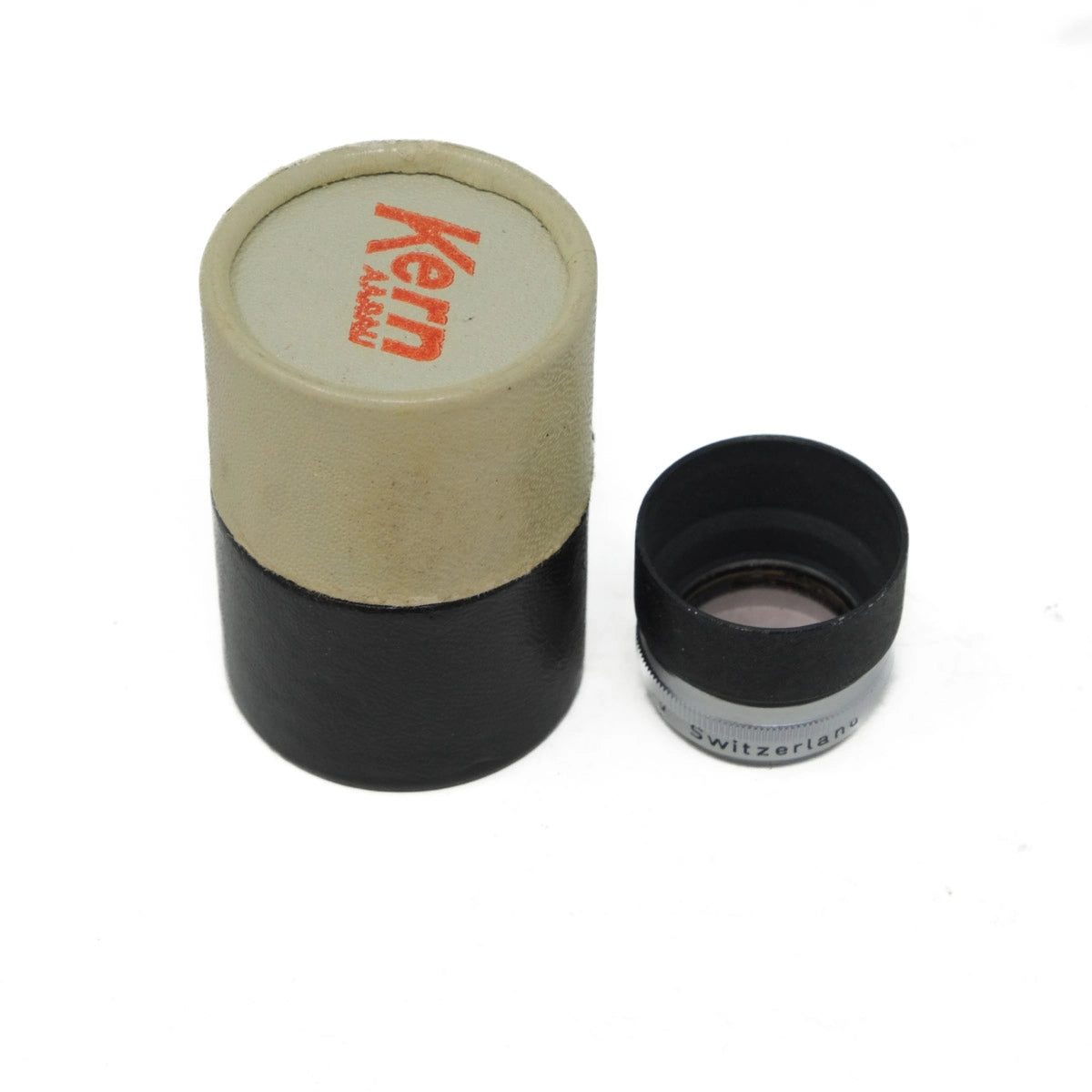 Camera lens with cardboard sleeve on a white background
