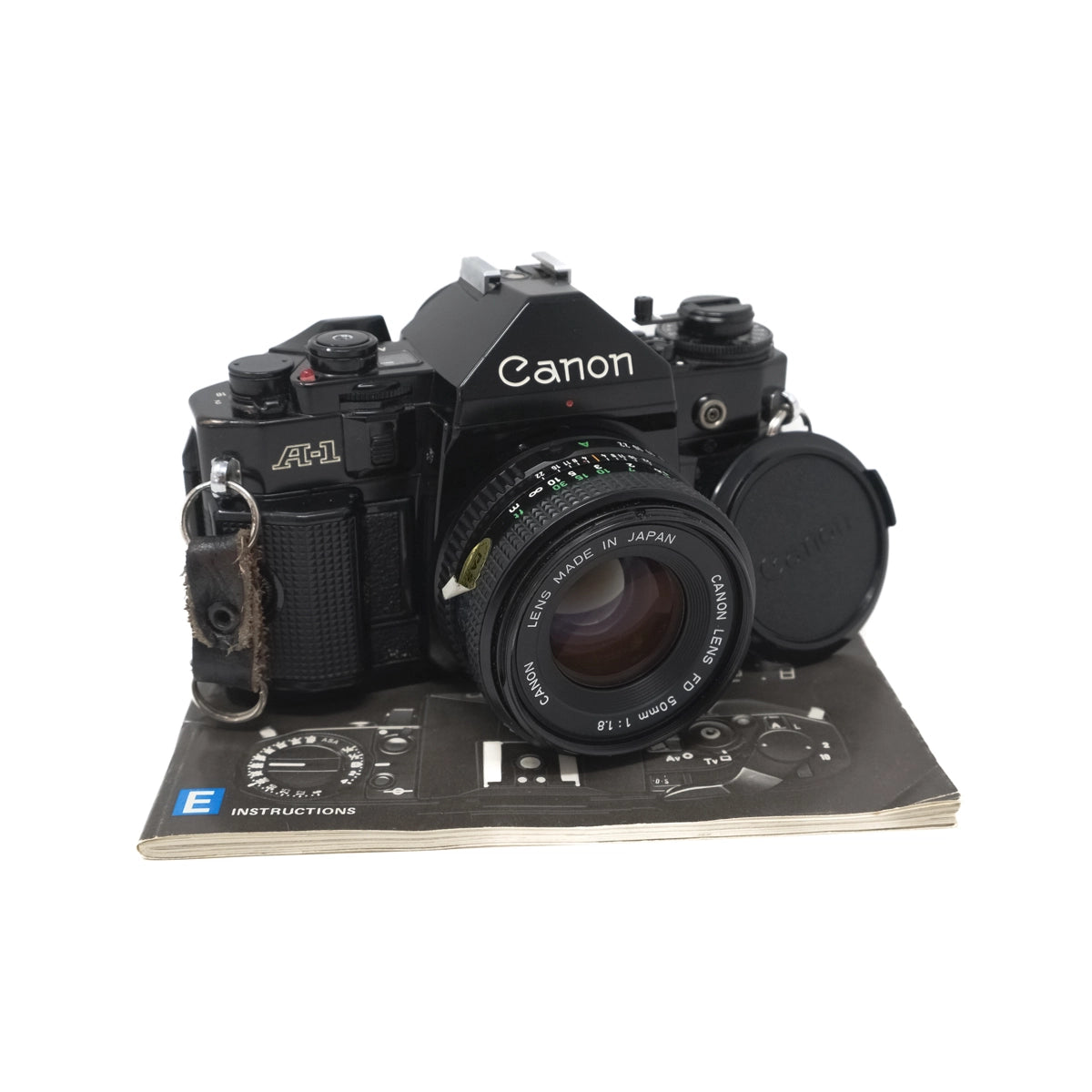 Used Canon A-1 film camera + 50mm F1.8 lens - Front angle without lens cap and with Instructions 